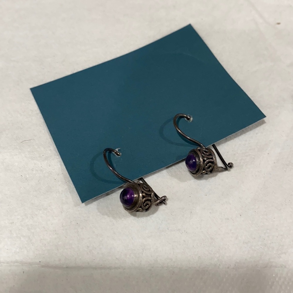 Purple stone dangle earrings.